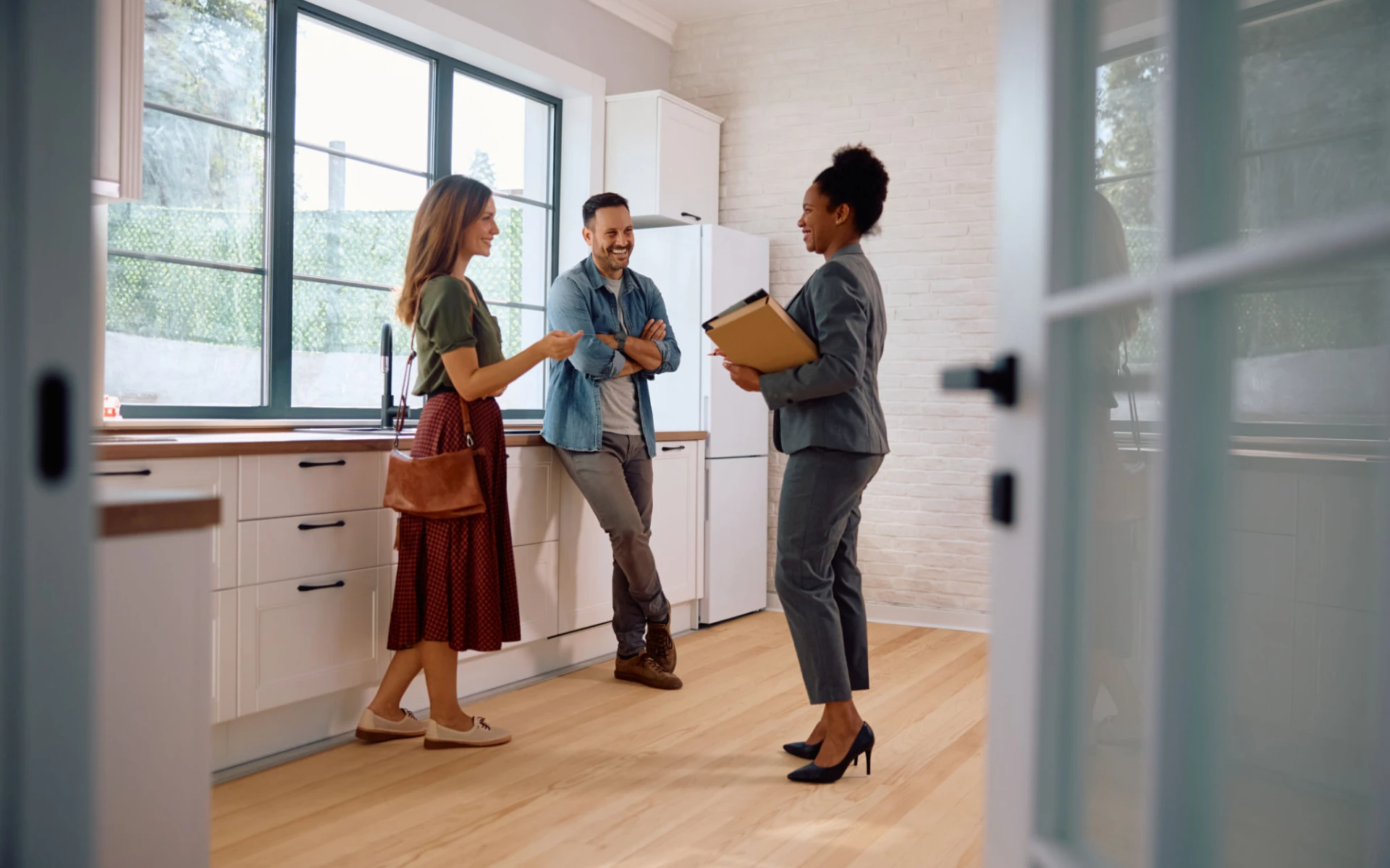Real estate discussion in bright kitchen space.